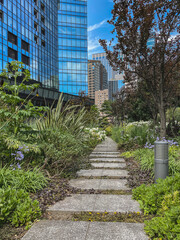 Urban landscape gardening central park city downtown Tokyo with flowers on bloom, trees and floral nature scenery peaceful tranquil recreation