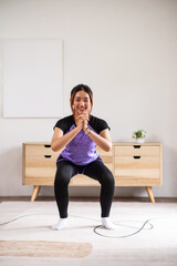 Asian women is doing forward lunge exercises at home