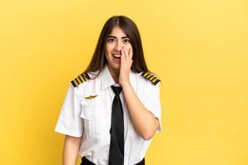 Airplane pilot isolated on yellow background with surprise and shocked facial expression
