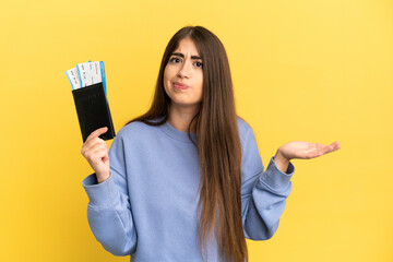 Young caucasian woman holding a passport isolated on yellow background having doubts while raising...
