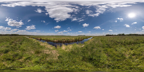 Fototapeta na wymiar spherical 360 hdri panorama among green grass farming field near melioration reclamation canal in equirectangular seamless projection, as sky dome replacement, game development as skybox or VR content