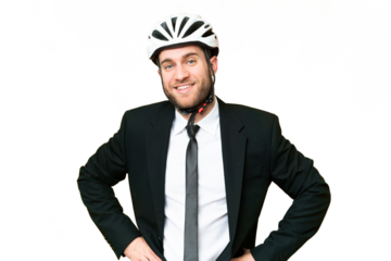 Business person with a bike helmet over isolated chroma key background posing with arms at hip and smiling