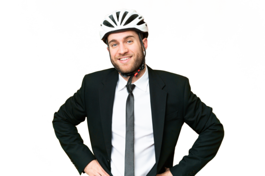 Business person with a bike helmet over isolated chroma key background posing with arms at hip and smiling