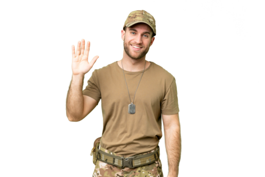 Military with dog tag over isolated chroma key background saluting with hand with happy expression