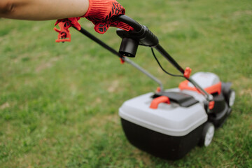 Lawn mover on green grass in modern garden. Machine for cutting lawns. Safety equipment with garden tools