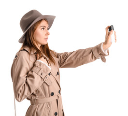 Young woman with pepper spray for self-defence on white background