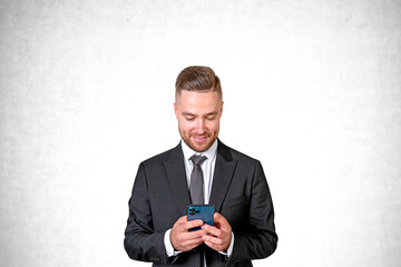 Businessman with smartphone in hands, happy portrait on copy space background
