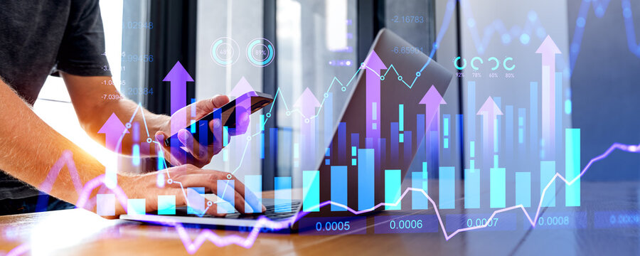 Man hands with laptop and smartphone and growing financial diagrams