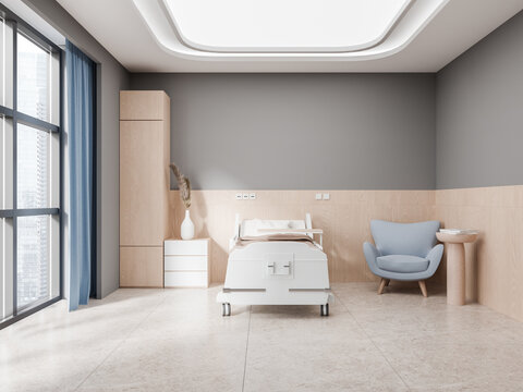 Stylish hospital room interior with bed, armchair and panoramic window