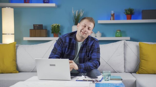 Home office worker man looking smugly at camera.