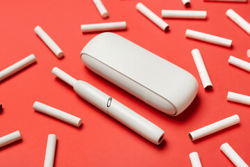 Composition with modern electronic cigar and sticks on red background