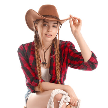 Young cowgirl with lasso on white background