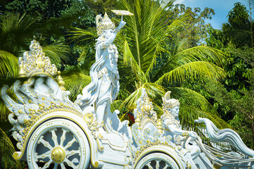 Close Up Side View Krishna Chakra Chariot Statue Of The Park With Plants And Trees During The...