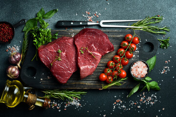 Juicy raw veal with steak spices on a stone background. Veal, meat. Top view. - obrazy, fototapety, plakaty