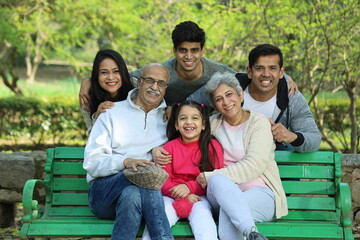 Happy Indian family with grandparents enjoying in the greenery