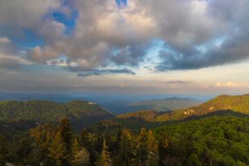 Naklejka premium Large clouds at dusk above the forested mountains, Bijele stijene reserve in Croatia