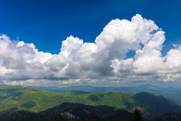 Large clouds above the forested mountains, Bijele stijene reserve in Croatia