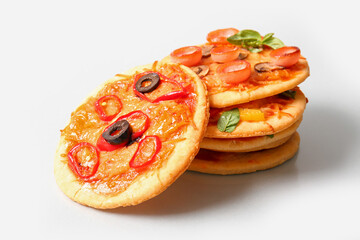 Different tasty mini pizzas on grey background