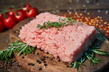 Raw meat in the form of minced meat on a wooden cutting board. Raw food for cooking.
