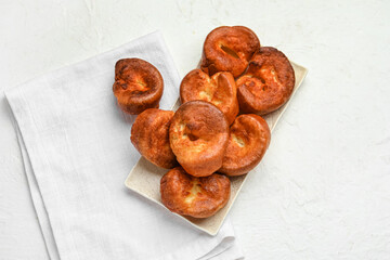 Plate with tasty Yorkshire pudding on light background