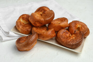 Plate with tasty Yorkshire pudding on light background