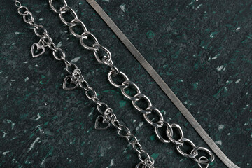 Fototapeta na wymiar Beautiful chain bracelets and necklace on black background