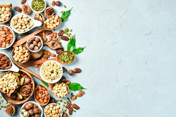 Assortment of nuts in bowls. Cashew, hazelnuts, walnuts, pistachio, pecans, pine nuts, peanut. Food...