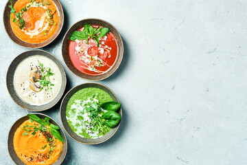 Dietary cream soups from vegetables. Colored soups in a bowl. Healthy food concept. Advertising photo.