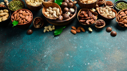 Assorted shelled nuts: walnuts, cashews, hazelnuts, Brazil nuts, almonds. Close up, macro. Assortment of shelled nuts. Side view. on the texture table.