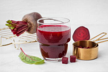 Glass of fresh beetroot juice on white background