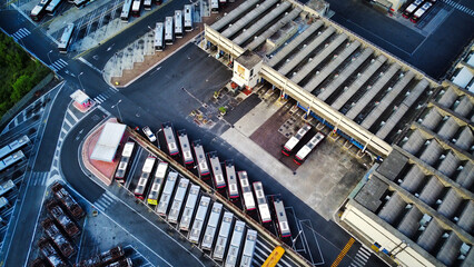 Bus depot red buses top-down view aerial drone shot