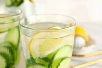 Glasses of infused water with cucumber slices, closeup