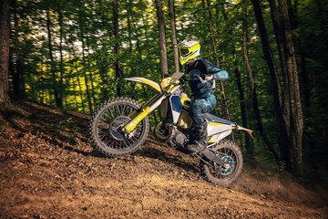 Motorcyclists trains in the forest.