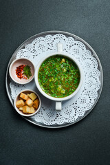 Chicken broth with parsley in a white bowl. Free space for text. Close up.