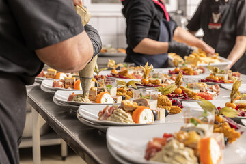 Chef in decorating an appetizer plate
