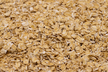 Pile of oatmeal or oat flakes as background. Close-up oatmeal