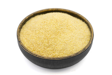 Dry organic semolina flour isolated on white background. Uncooked organic semolina in bowl