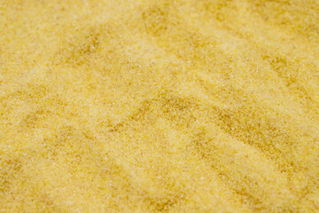 Pile of dry organic semolina flour as background. Close-up Uncooked organic semolina
