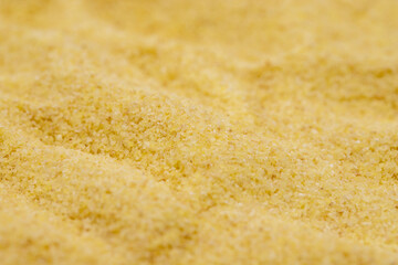 Pile of dry organic semolina flour as background. Close-up Uncooked organic semolina