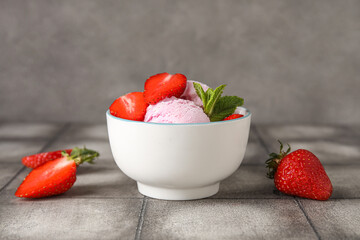 Bowl of delicious ice cream scoops with fresh strawberries and mint on grey grunge table