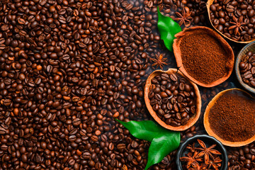 Roasting coffee beans with smoke on a dark background. Arabica or robusta coffee. Coffee background. Top view.