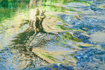 flow of water and spray from a stone