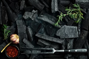 Foto op Aluminium Barbecue. Meat fork, rosemary and charcoal. Top view. Space for text. © Yaruniv-Studio