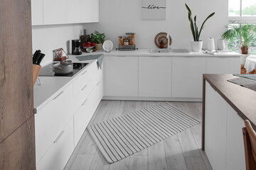 Stylish striped carpet in interior of modern kitchen