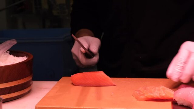 Closeup of cutting salmon fish in Tsukiji Outer Market, Tokyo, Japan.