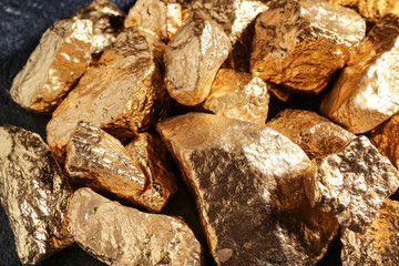Golden nuggets on dark background, closeup