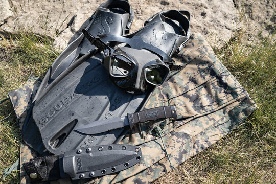 Estonia, Tallinn June 8, 2023: Combat swimmer equipment, diving mask, scubapro fins, sog marines knife.