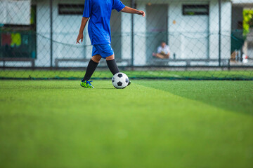 Soccer ball tactics children control the ball on a grass field for the training