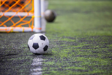 Fototapeta na wymiar Soccer ball on a grass field for a soccer goal the training