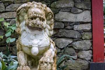 Asian lion sculpture in Madeira garden